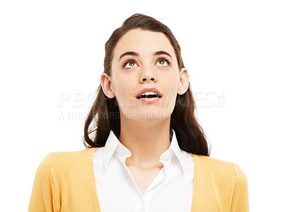 Buy stock photo A woman thinking and looking pensive isolated against white studio background. A young curious female gently looks upwards in wonder and contemplates while looking at a copy space advertisement 