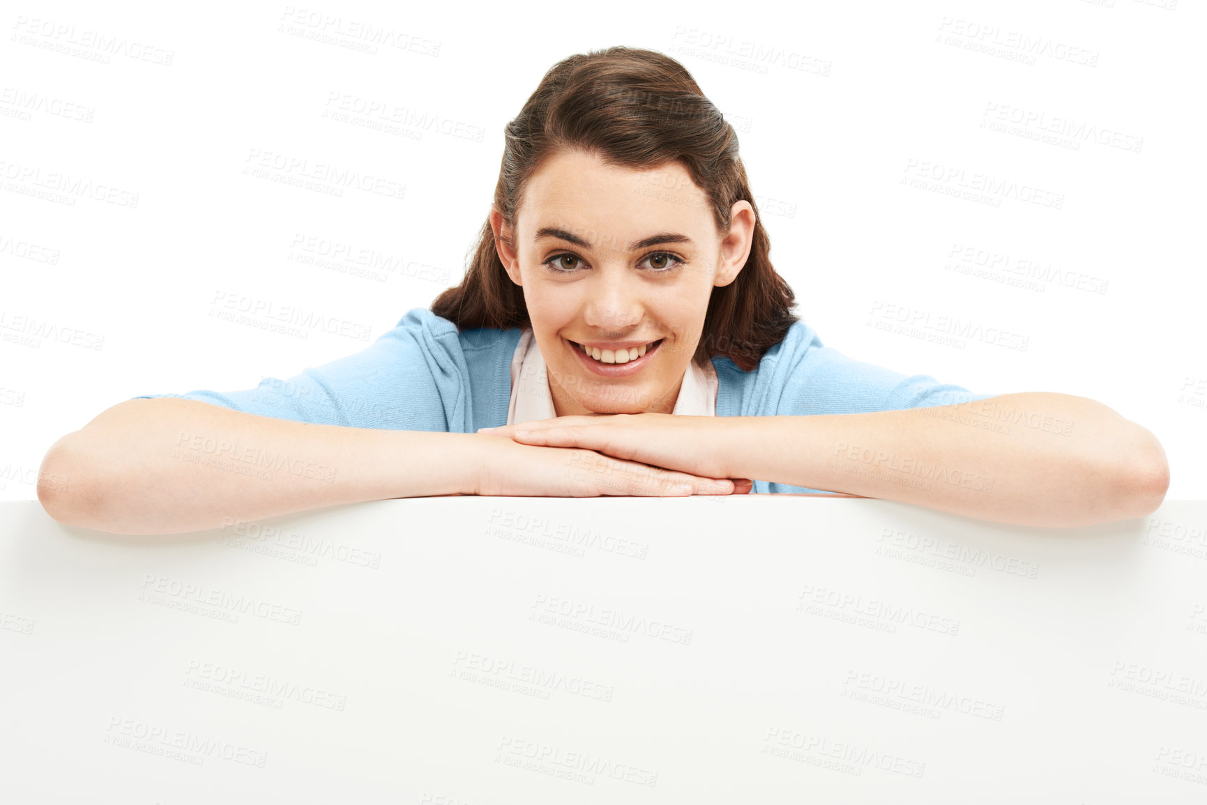 Buy stock photo Smiling young woman leaning over a billboard of copyspace