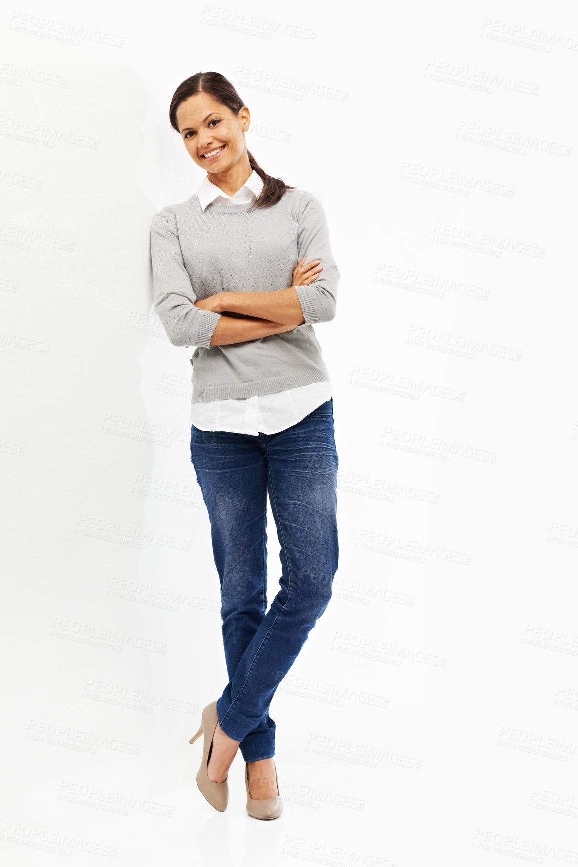 Buy stock photo Studio portrait of an attractive young woman standing with her arms crossed isolated on white