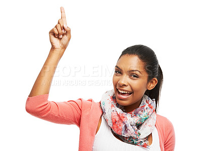 Buy stock photo An attractive young woman pointing upwards