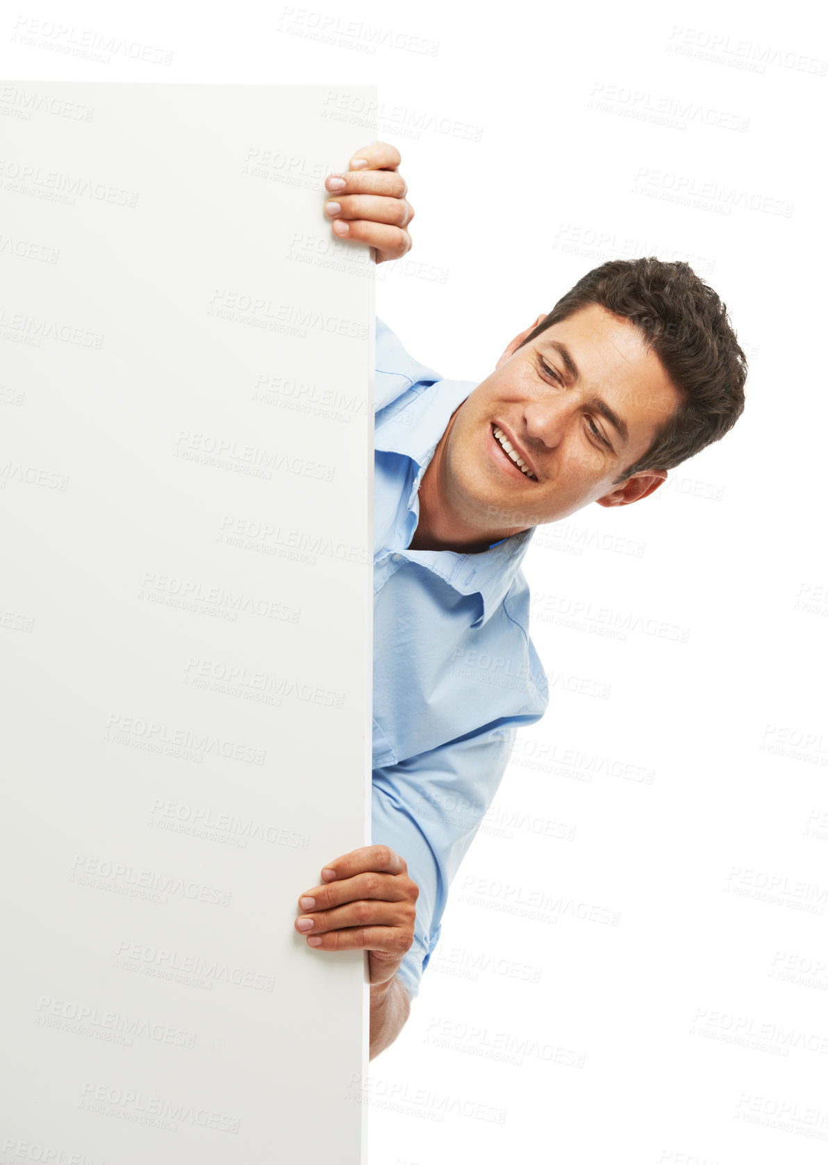 Buy stock photo Peek, happy man and poster sign for advertising, mockup or space isolated on white studio background. Person, peep and banner board for promo, news or information for commercial placeholder or design