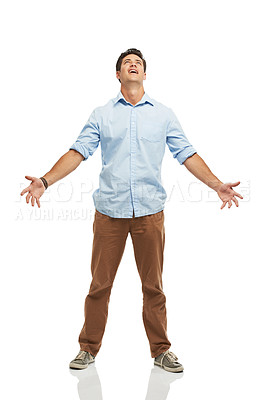 Buy stock photo A young man looking to the skies with his arms open - isolated