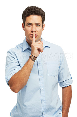 Buy stock photo A handsome young man with a finger to his lips isolated on a white background