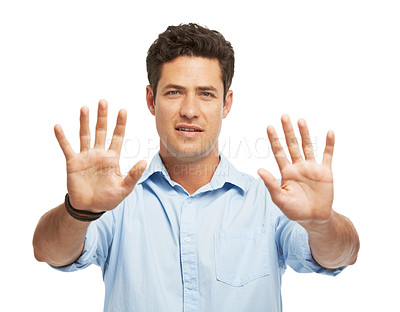 Buy stock photo A young man holding out both of his palms while isolated on white