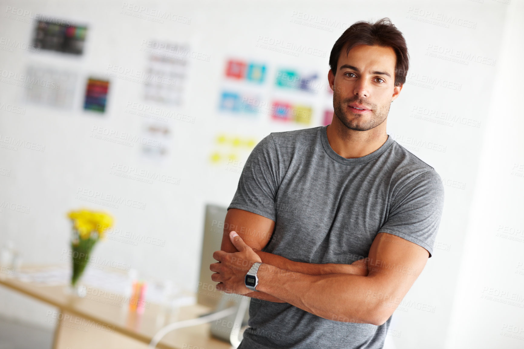 Buy stock photo Portrait of a handsome young man standing in an office with arms crossed