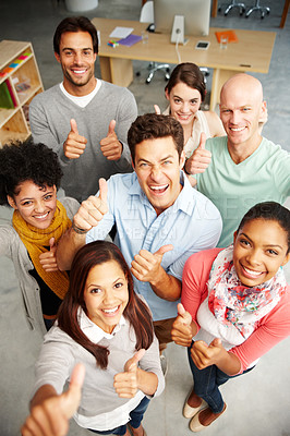 Buy stock photo High angle view portrait of a group of multi-ethnic people holding thumbs up in a work environment