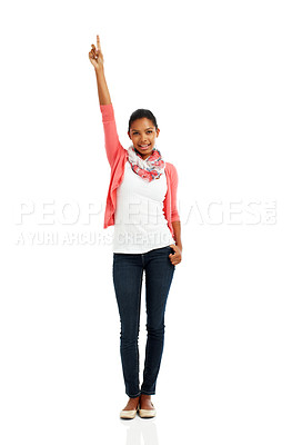 Buy stock photo A full body portrait of a pretty young woman posing with one arm raised and finger pointing up against a white background
