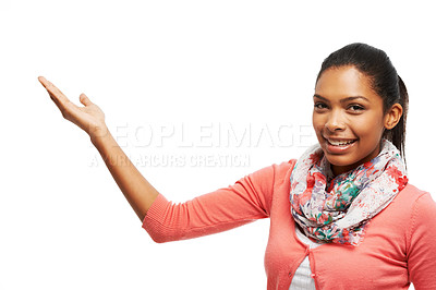 Buy stock photo Portrait of a beautiful young woman pointing at your product against a white background