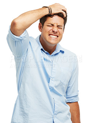 Buy stock photo A handsome young man holding his head in pain against a white background