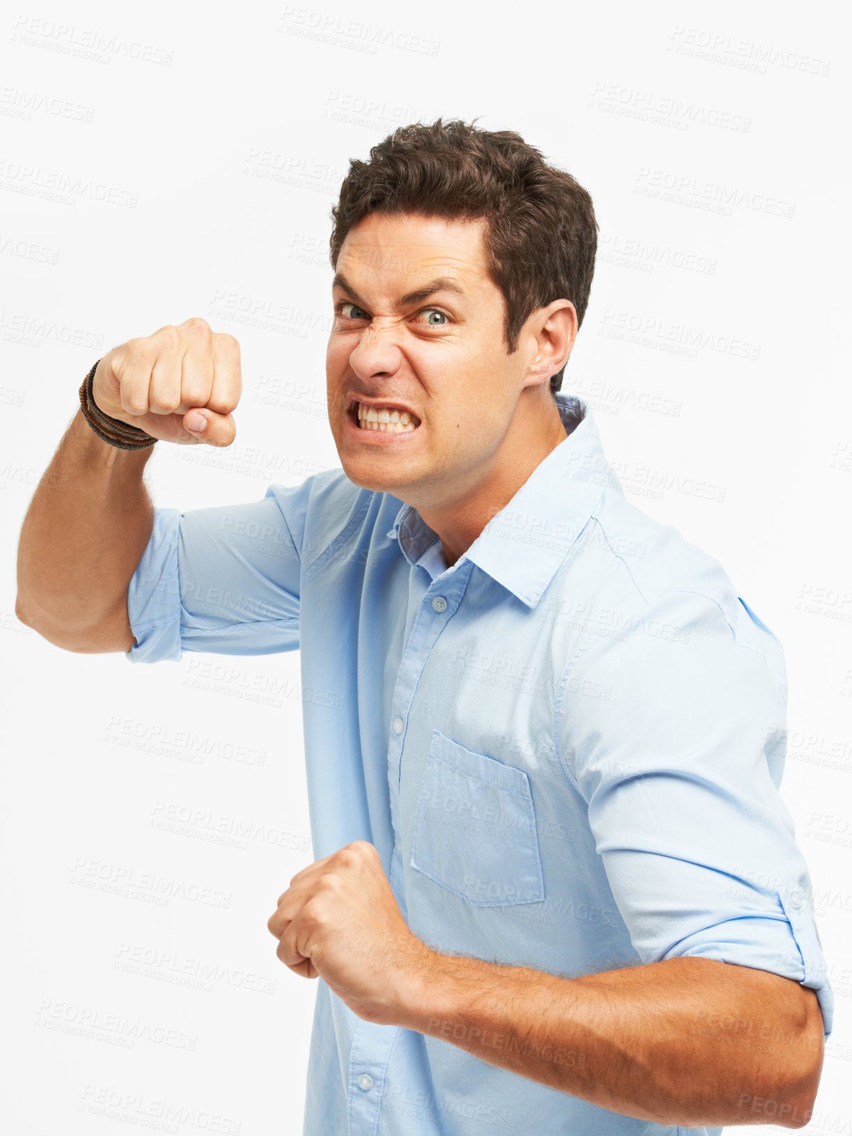 Buy stock photo Portrait, man and angry with fist for violence, conflict and aggressive on white background for emotion. Male person, ready and punch as unhappy in studio with frustrated in upset, annoyed or furious