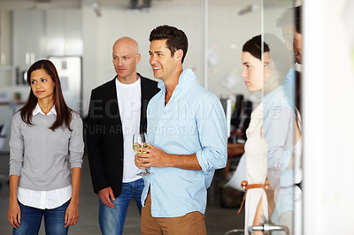 Buy stock photo A handsome young man with a glass of wine in his hand at a office social