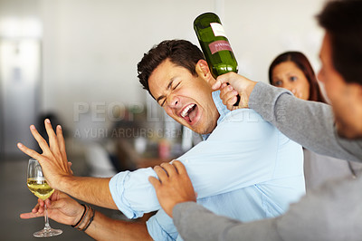 Buy stock photo A drunk man holding a glass of wine getting hit over the head with a wine bottle