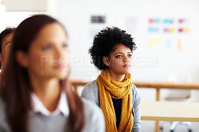 Buy stock photo A beautiful young woman sitting and listening to a presentation