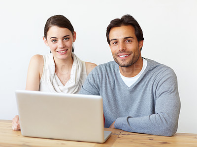 Buy stock photo Portrait of a handsome man and a beautiful young woman working together on a laptop