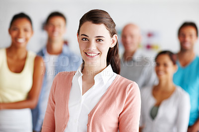 Buy stock photo A young woman standing in front of her colleagues in their office
