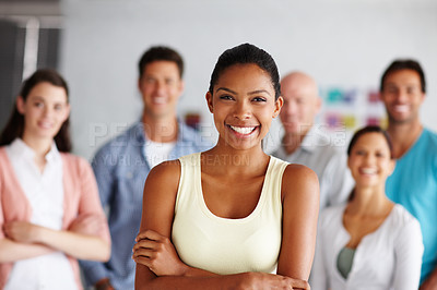 Buy stock photo A young woman standing in front of her colleagues in their office