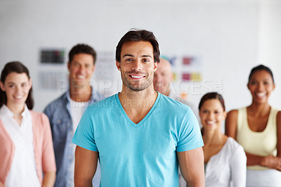 Buy stock photo A young man standing in front of his colleagues in their office