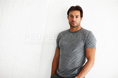 Buy stock photo Man, portrait and serious style in home, confidence and casual t shirt for fashion by white background. Male person, mockup space and wall for streetwear aesthetic, guy and cool clothes or outfit