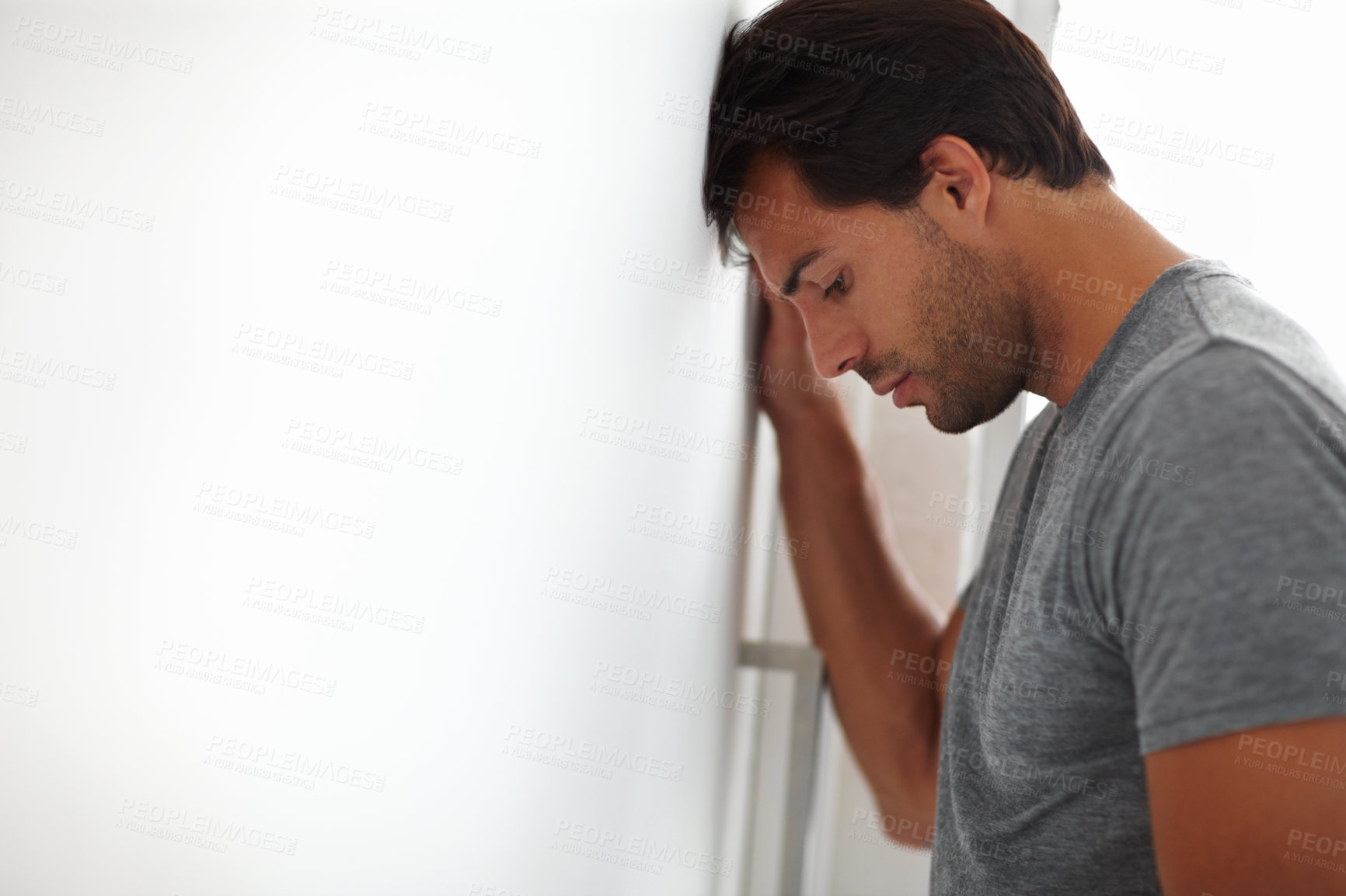 Buy stock photo Sad, mental health and man by wall with stress for infidelity, cheating and divorce by mockup space. Frustration, mistake and male person with regret for breakup with anxiety for failure in home.