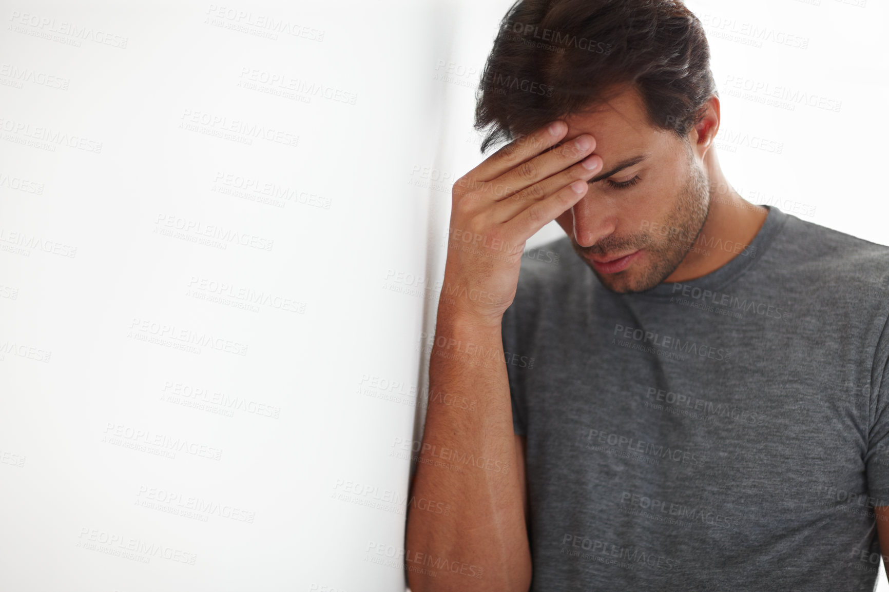 Buy stock photo Frustrated, mental health and man by wall with stress for infidelity, cheating and divorce by mockup space. Upset, mistake and male person with regret for breakup with anxiety for failure in home.