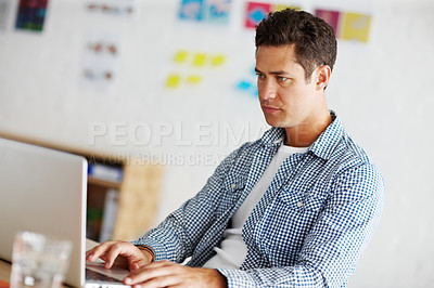 Buy stock photo Graphic designer, man and typing in office with laptop for process, thinking and problem solving at company. Person, employee and reading with computer for project management at creative agency