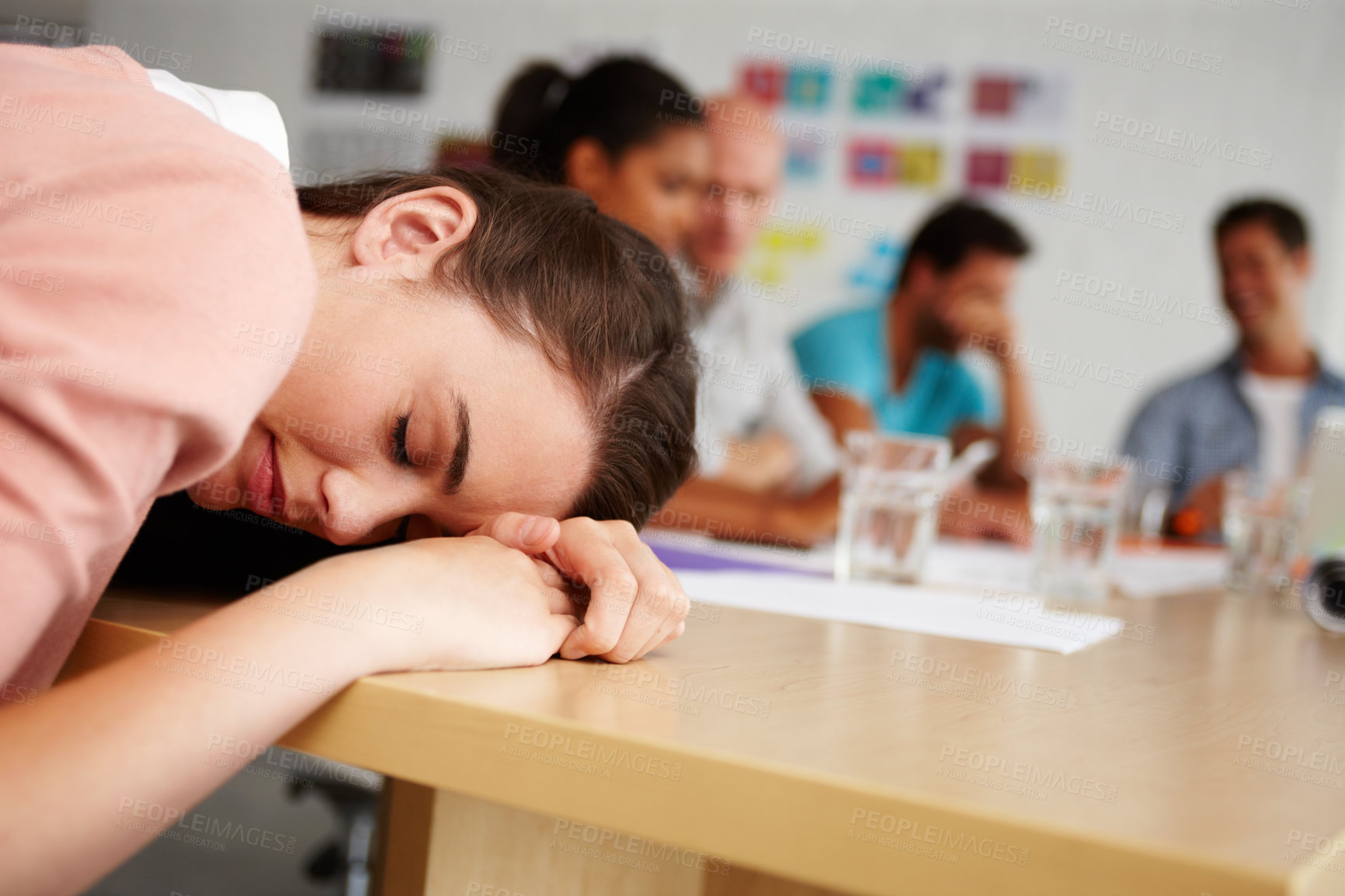 Buy stock photo Woman, sleeping and tired at meeting in office with fatigue, exhausted or incompetent in group at company. Employee, person and rest on desk with burnout, team and lazy with job at creative agency