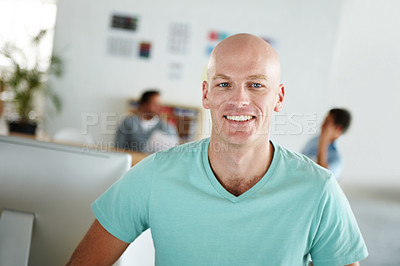 Buy stock photo Portrait of a positive-looking young professional with his colleagues working in the background