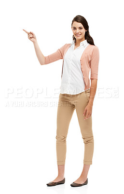 Buy stock photo Full length portrait of an attractive young woman pointing towards your copyspace