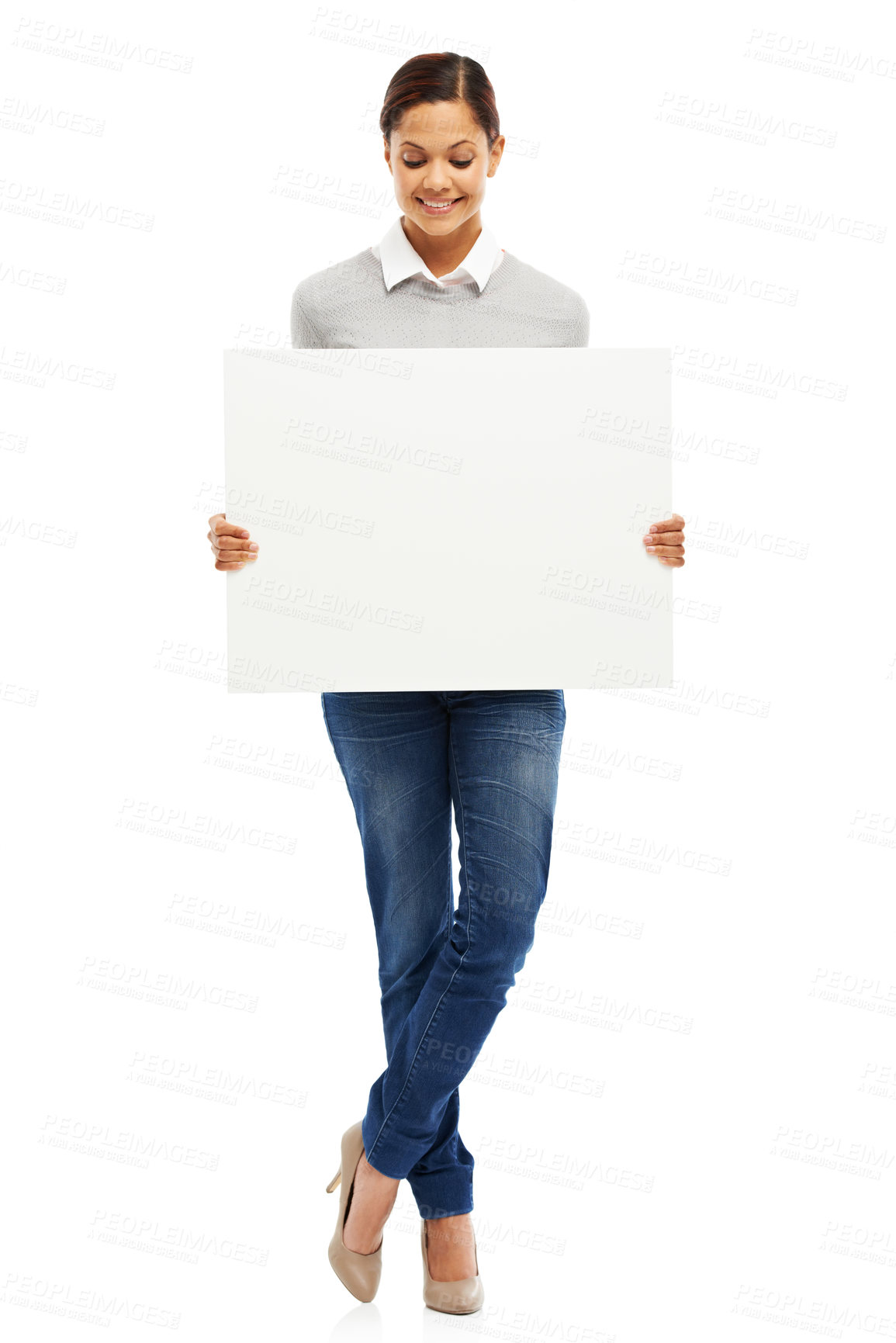 Buy stock photo Studio portrait of an attractive young woman holding a blank placard isolated on white