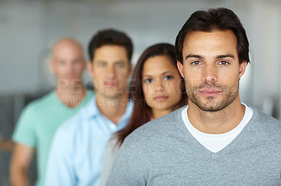 Buy stock photo Portrait of a four focused-looking young designers standing in an office