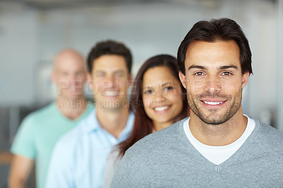 Buy stock photo Portrait of a four smiling young designers standing in an office