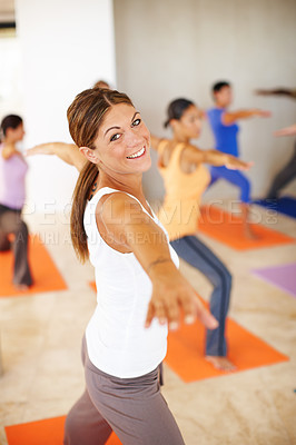 Buy stock photo A gorgeous young woman in a yoga class in a yoga position