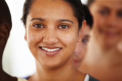 Buy stock photo Close up portrait of a happy-looking young woman standing in a line with other yoga students