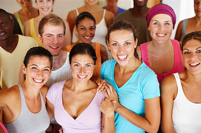 Buy stock photo Portrait of a a group of yoga enthusiasts standing in a yoga studio