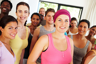 Buy stock photo Portrait of a a group of yoga enthusiasts standing in a yoga studio