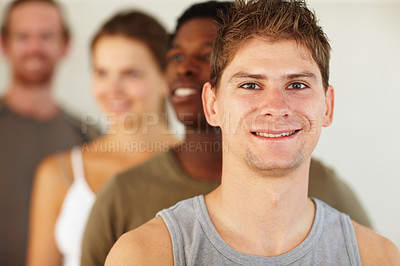 Buy stock photo Portrait, smile or fitness and man with a group of people in a studio for health, wellness or mindfulness. Exercise, workout and pilates with a happy young person in gym class for holistic training