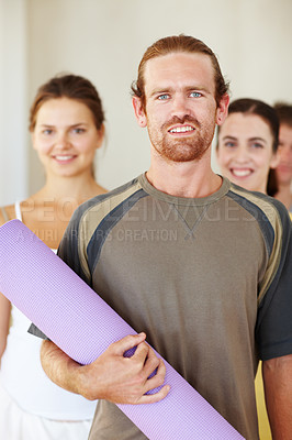 Buy stock photo Portrait, yoga or exercise mat and man with a group of people in a studio for health, wellness or mindfulness. Fitness, training and pilates with happy young friends in gym class for holistic balance