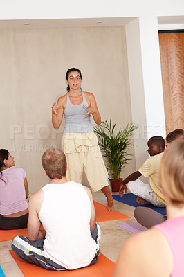 Buy stock photo Woman, yoga and talk for coaching, group or presentation for health, wellness or self care in class. Personal trainer, speaker and people in audience, floor or pilates training in morning at studio