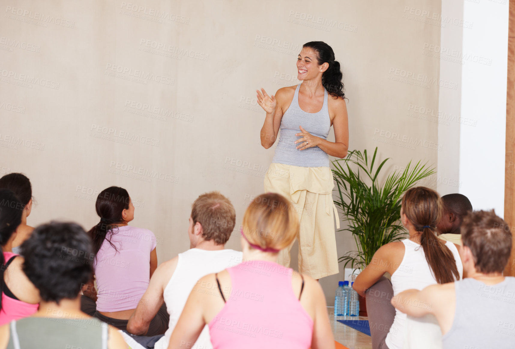 Buy stock photo Woman, yoga instructor and talk with group, class or presentation for health, wellness and advice for self care. Personal trainer, coach and people in audience, floor and mock up space at studio