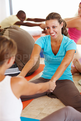 Buy stock photo Women, holding hands and warm up with stretching at gym for yoga class, happy and help for health on floor. People, friends and partner for support, fitness or smile for conversation at wellness club