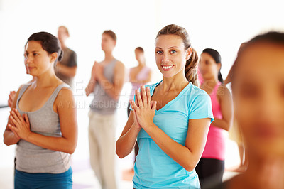 Buy stock photo Portrait of a young woman with her hands together performing a yoga routine
