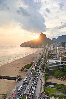 Buy stock photo Beach, city and coastal with mountain or building infrastructure or architecture, travel or ocean. Vacation, sand and shoreline in Rio de Janeiro or urban location for Brazil trip, sunset or summer