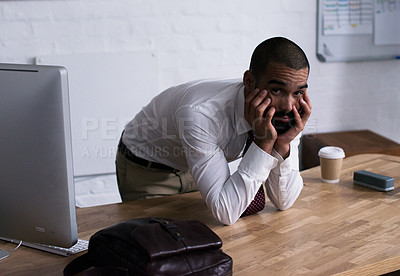 Buy stock photo Portrait of a tired businessman leaning on his office desk. Real life businesspeople shot on location. Since these locations are the real thing, and not shot in an 