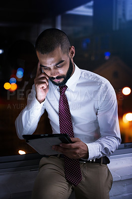 Buy stock photo Shot of a businessman talking on his cellphone late at night. Real life businesspeople shot on location. Since these locations are the real thing, and not shot in an 