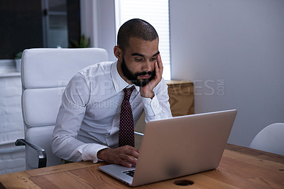 Buy stock photo Shot of a businessman working on his laptop late at night. Real life businesspeople shot on location. Since these locations are the real thing, and not shot in an 