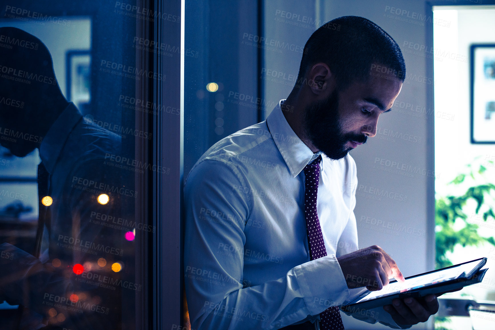 Buy stock photo Working, male professional and tablet in office at night for strategy, research and planning corporate growth. Businessman, reading and emailing on digital device for job, company or connectivity 