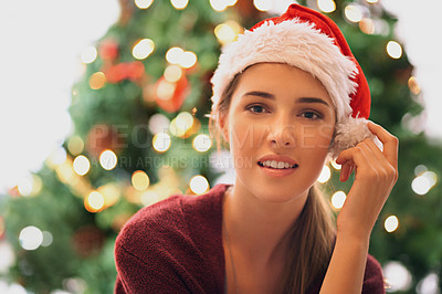 Buy stock photo Christmas tree, woman and holiday celebration portrait with a young model in santa hat to celebrate Christian tradition. Headshot of a young female happy about new year and festive, season at, home