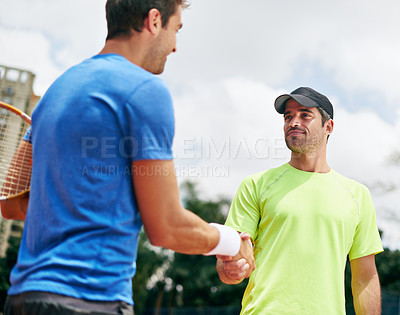 Buy stock photo Shot of two tennis players shaking hands