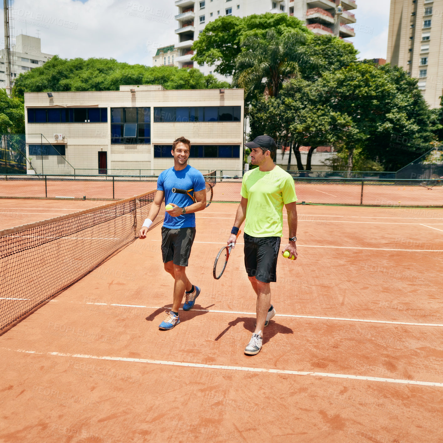 Buy stock photo Shot of  two tennis players talking on the court
