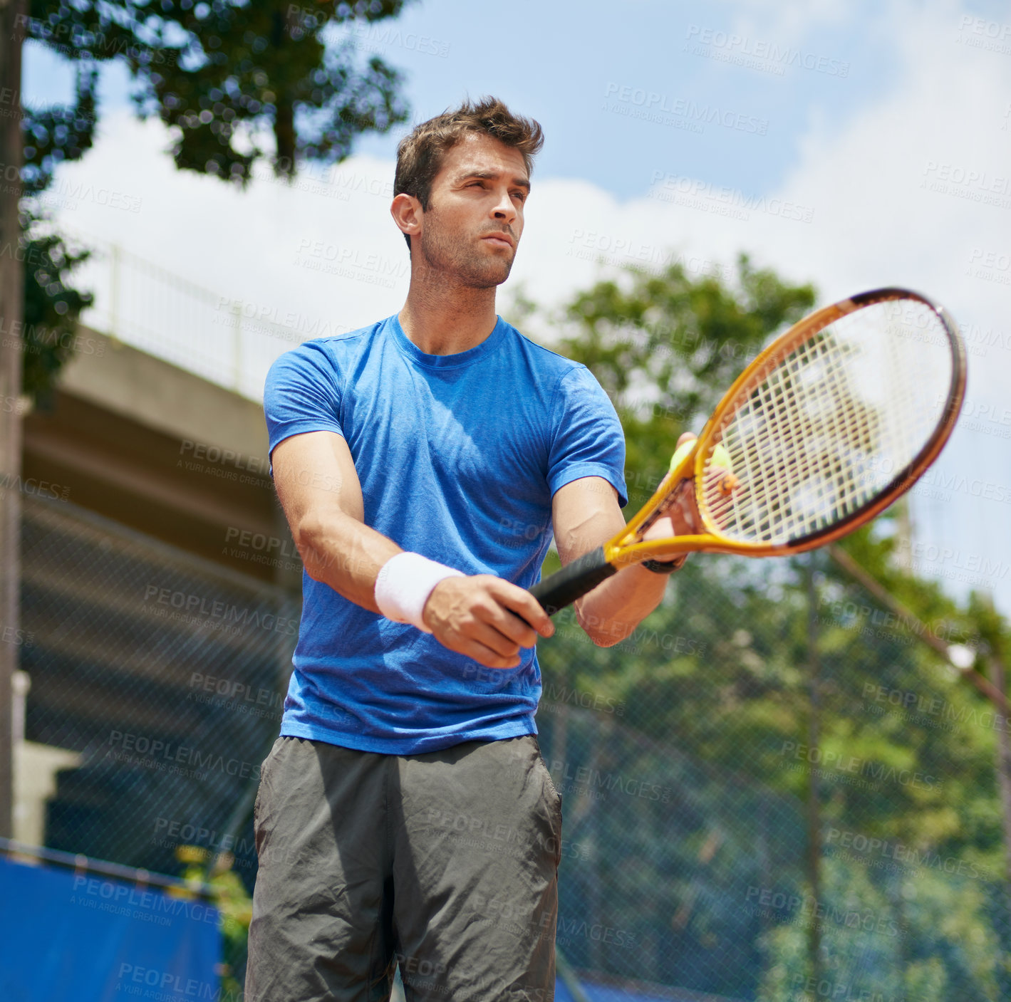 Buy stock photo Shot of a young tennis player ready serve
